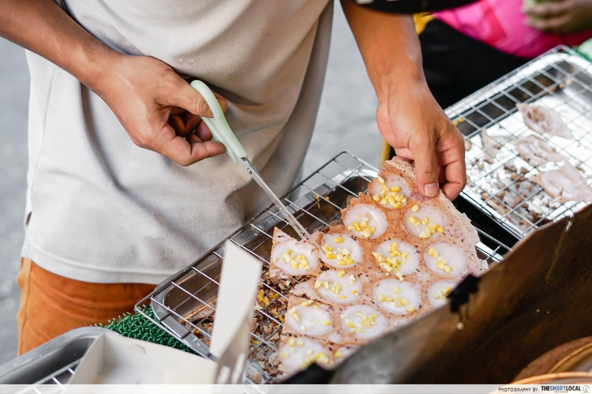 Assorted Thai street food being prepared in a market